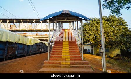 Railway station foot over staircase goes to Foot over bridge, inside view of station corridor, staircase of a foot over bridge at a rural railway stat Stock Photo