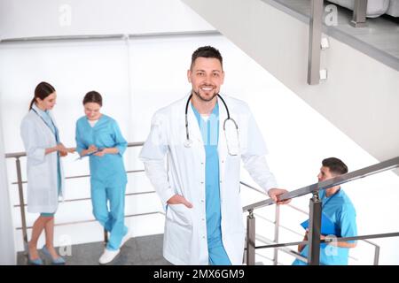 Male doctor going upstairs in modern clinic Stock Photo