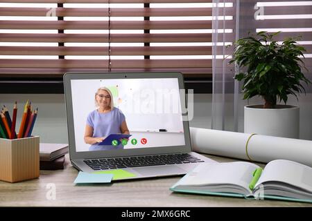 Modern laptop on wooden desk indoors. Online learning Stock Photo
