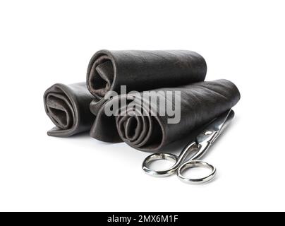 Black leather samples and craftsman scissors isolated on white Stock Photo