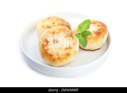 Delicious cottage cheese pancakes with mint isolated on white Stock Photo
