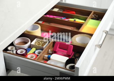 Different stationery in open desk drawer indoors Stock Photo