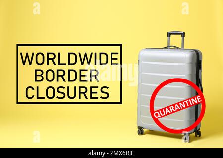 Worldwide border closures through quarantine during coronavirus outbreak. Suitcase and prohibition sign on yellow background Stock Photo