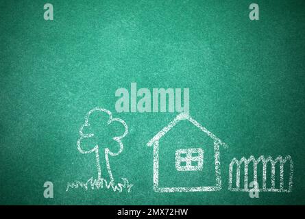 House and tree drawn with chalk on school board Stock Photo