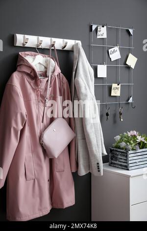 Hallway interior with stylish furniture, clothes and accessories Stock Photo