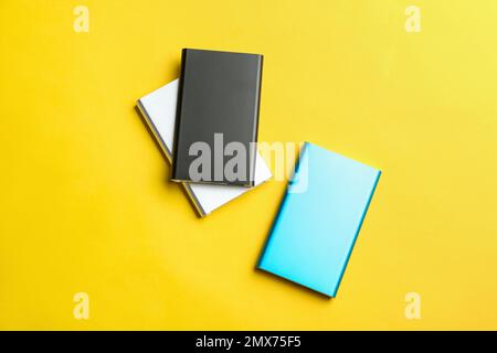 Modern external portable chargers on yellow background Stock Photo