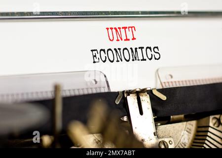 Unit economics symbol. Concept words Unit economics typed on old retro typewriter. Beautiful white background. Business and unit economics concept. Co Stock Photo