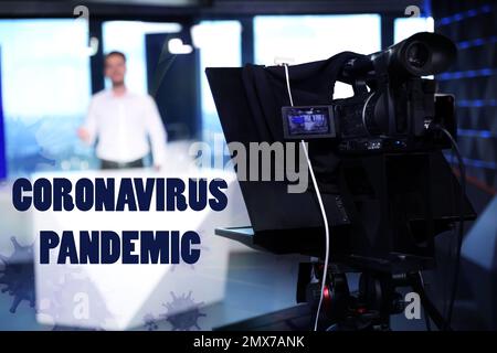 Presenter working in studio. Coronavirus pandemic - latest updates Stock Photo