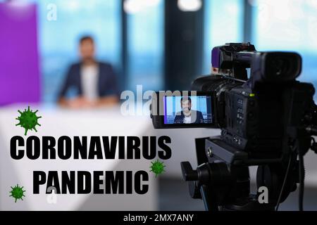 Presenter working in studio. Coronavirus pandemic - latest updates Stock Photo