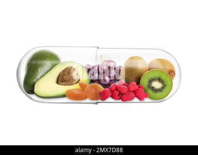 Transparent capsule with different fruits and berries rich in vitamins on white background Stock Photo