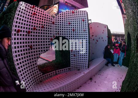 Tourists crowd “Love's h|Edge”, the winner of the 15th Annual Times Square Love & Design Competition in Times Square in New York on Wednesday, February 1, 2023. Designed by Almost Studio, the Valentine’s Day sculpture consists of heart-shaped “hedges” giving visitors a maze-like secret garden, and lots of selfie opportunities. The sculpture will be on display through February 28.(© Richard B. Levine) Stock Photo