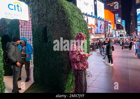 Tourists crowd “Love's h|Edge”, the winner of the 15th Annual Times Square Love & Design Competition in Times Square in New York on Wednesday, February 1, 2023. Designed by Almost Studio, the Valentine’s Day sculpture consists of heart-shaped “hedges” giving visitors a maze-like secret garden, and lots of selfie opportunities. The sculpture will be on display through February 28.(© Richard B. Levine) Stock Photo