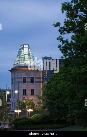 The United States of America embassy building through Major's Hill park at dusk in spring, Ottawa, Ontario, Canada. Stock Photo