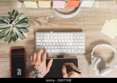 Man or photographer working on digital tablet retouching images. Graphic designer workplace. Stock Photo