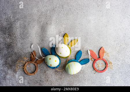 From above flat lay with eggs for Easter holiday concept on concrete background Stock Photo