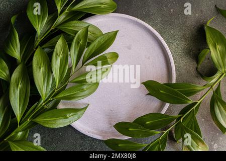 From above table setting with green italian ruscus leaves Stock Photo