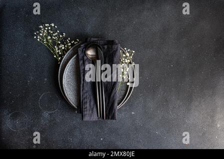Top view of rustic summer table setting with plate and cutlery decorated with cushion baby's-breath Stock Photo