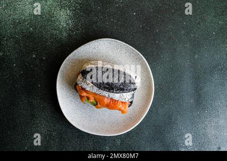 Healthy snack with sour dough and activated carbon bun and salmon fish in  sandwich Stock Photo - Alamy