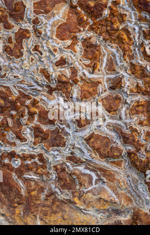 Textured background of rough rocky brown surface with uneven gray cracks and lines Stock Photo