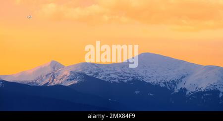 Winter landscape at sunrise, panorama, banner - view of the mountain range, Carpathian mountains in Ukraine