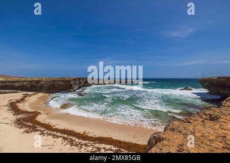 Gorgeous  view of big turquoise waves Atlantic ocean on western rocky coast of island of Aruba. Stock Photo