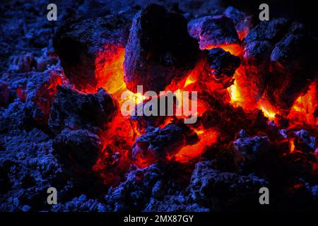 The red hot glowing embers after the flames of a campfire burnt out Stock Photo