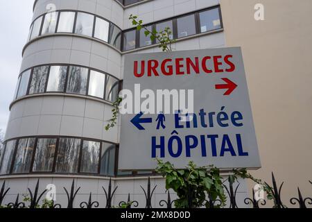 Sign written in French indicating the directions of the emergencies department and the pedestrian entrance of a hospital in France Stock Photo