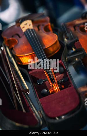 Abstract blurred background of Violin and bow in dark red case. Classical music concept Stock Photo