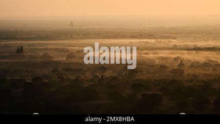 Aerial view of Burmese temples at sunrise on a foggy morning in Bagan, Myanmar (Burma). Stock Photo