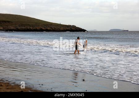 Brave mature couple winter swimming at Barry Island. January 2023. Winter Stock Photo