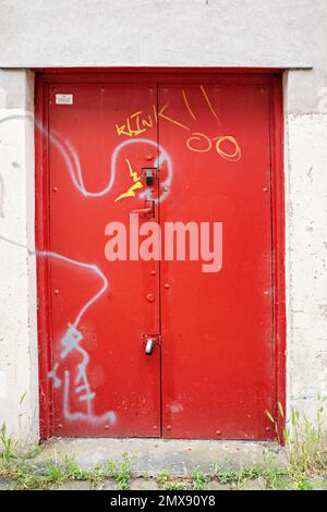 Red painted steel side doorway to Garage Stock Photo
