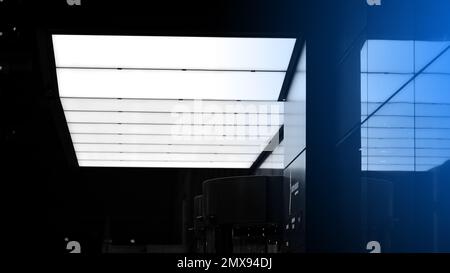 Pattern of office buildings windows illuminated at night. Lighting with Glass architecture facade design with reflection in urban. Black and white. Stock Photo