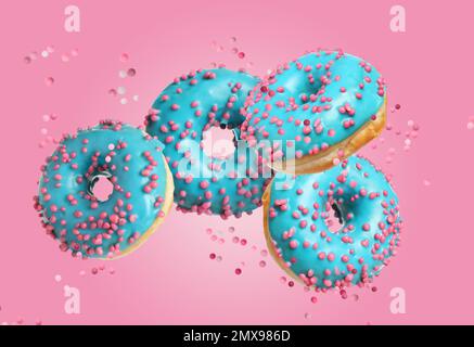 Set of falling delicious donuts on pink background Stock Photo