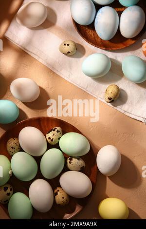 Composition with beautiful painted and natural Easter eggs on color background Stock Photo