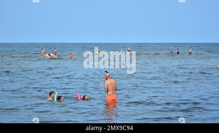 Miedzyzdroje, Poland. 22 July 2021. View of the beach. Tourists, sunbeds and windbreaks on summer hot day. Tourists on the beach on summer they sunbat Stock Photo