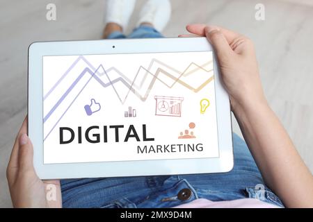 Digital marketing concept. Woman using modern tablet, closeup Stock Photo