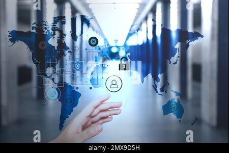 Woman activating protection against cyber attack, closeup. Digital icons and world map Stock Photo