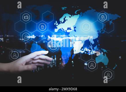 Woman activating protection against cyber attack, closeup. Digital icons and world map Stock Photo