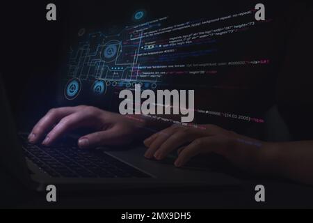 Hacker working with laptop at table, closeup. Cyber attack Stock Photo