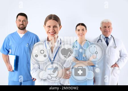 Group of doctors against light background. Medical service Stock Photo