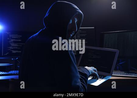 Hacker with computers in dark room. Cyber crime Stock Photo