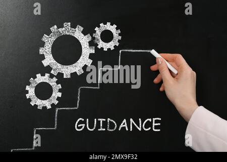 Team work concept. Woman drawing stairs near gears on chalkboard Stock Photo