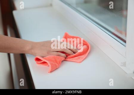 Cleaning a Window Sill with a Dust Cloth Stock Photo - Alamy