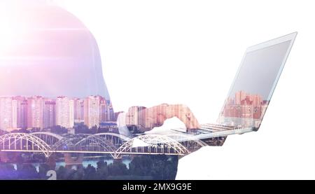 Double exposure of businessman using laptop and city landscape Stock Photo