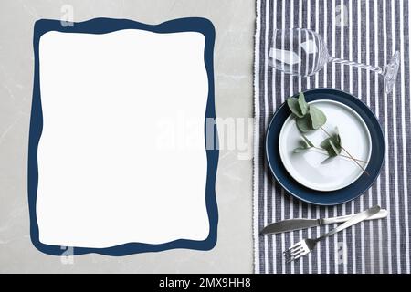 Elegant table setting and empty menu on grey marble table, flat lay. Space for text Stock Photo