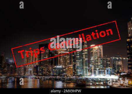 Trips cancellation during coronavirus quarantine. Night cityscape with illuminated buildings Stock Photo