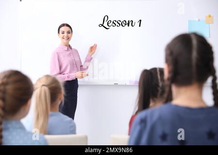 Young English teacher and pupils in classroom Stock Photo