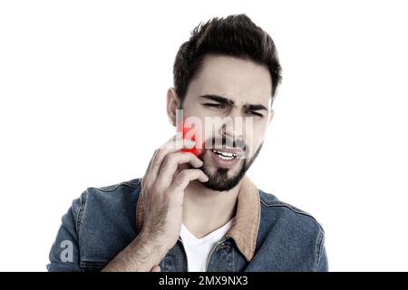 Young man suffering from toothache on white background Stock Photo