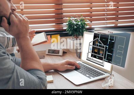 Engineers at work. Colleagues projecting house in office Stock Photo