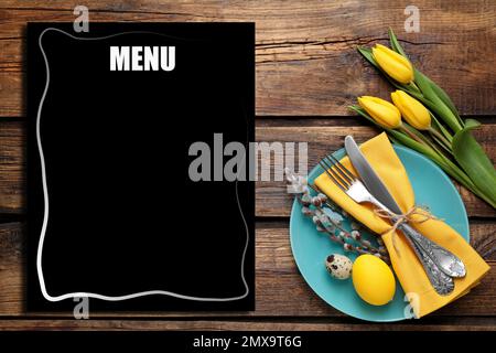 Festive table setting with tulips and empty menu, flat lay. Space for text Stock Photo